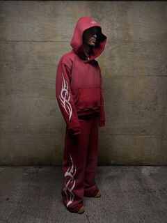 Male model wearing a custom manufactured red hoodie and matching sweatpants with tribal graphic print