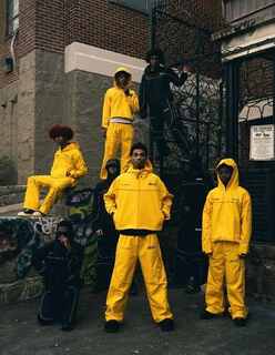 Group of five people wearing custom manufactured streetwear jackets and windbreakers by a car